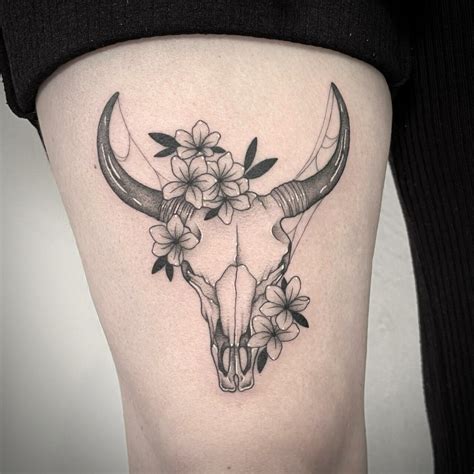 Skull Horns and Flowers Thigh Tattoo