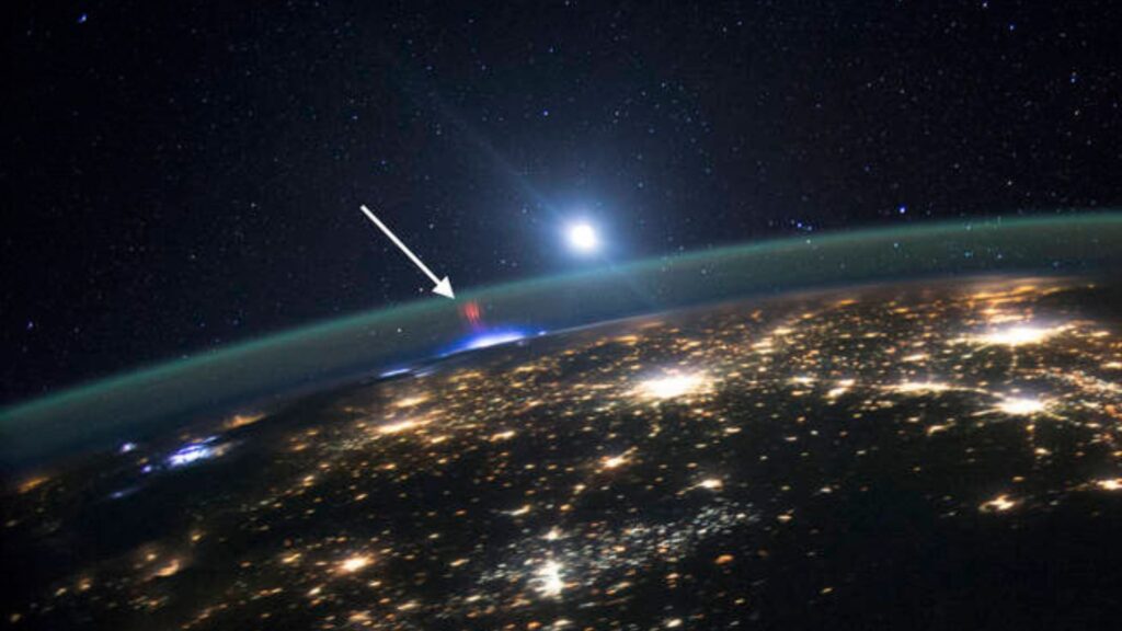 A red sprite (highlighted by a white arrow) was photographed over a thunderstorm by Expedition 44 Crew members aboard the International Space Station on August 10, 2015. Credits: NASA.